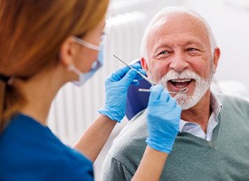Man smiles at dentist