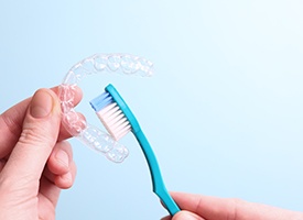 Patient cleaning clear aligner with toothbrush