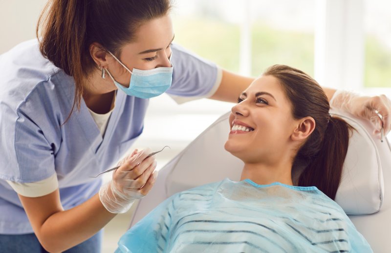 A dentist chatting with one of her patients