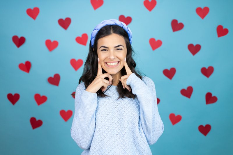 woman smiling while surrounded by hearts